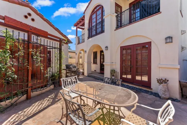 a front view of a house with outdoor seating