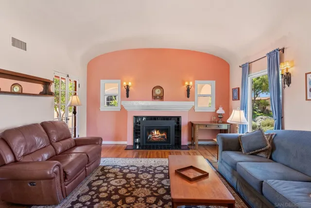 a living room with furniture and a fireplace