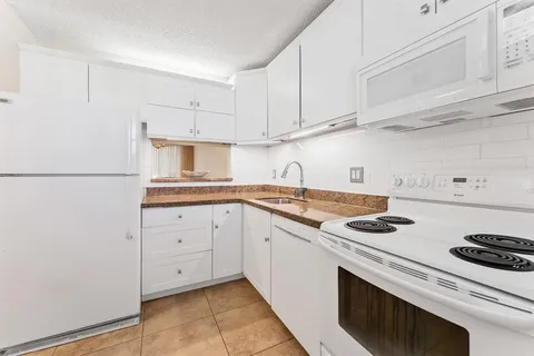 a bedroom with two beds and wooden floor