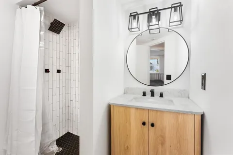 a tall building with a large parking space and a car parked in front of it