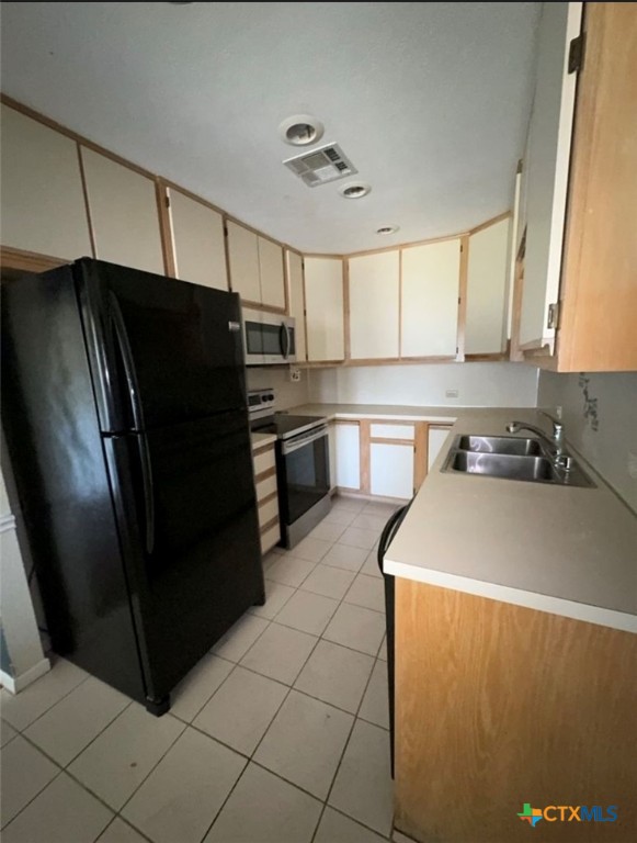 1417 Camilla Road Killeen, TX 76549 - Photo 16 of 22 a kitchen with stainless steel appliances a refrigerator sink and cabinets