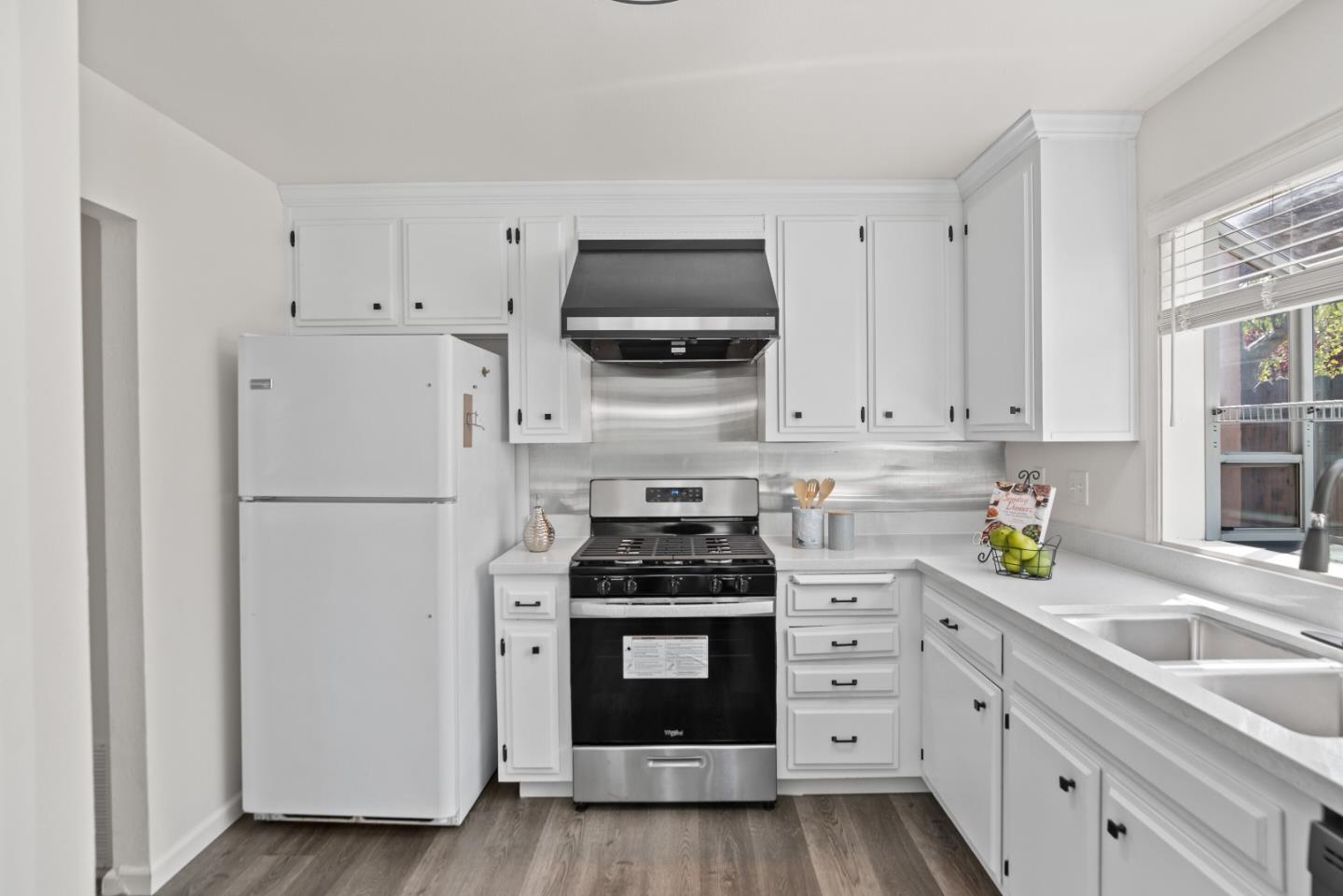 773 Andrea Way Pittsburg, CA 94565 - Photo 12 of 35 a kitchen with white cabinets and stainless steel appliances
