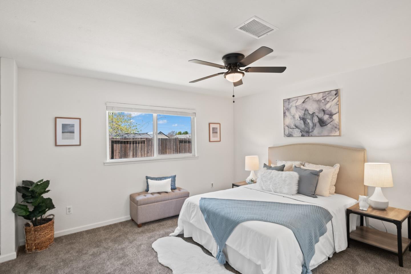 773 Andrea Way Pittsburg, CA 94565 - Photo 16 of 35 a spacious bedroom with a bed and a chandelier