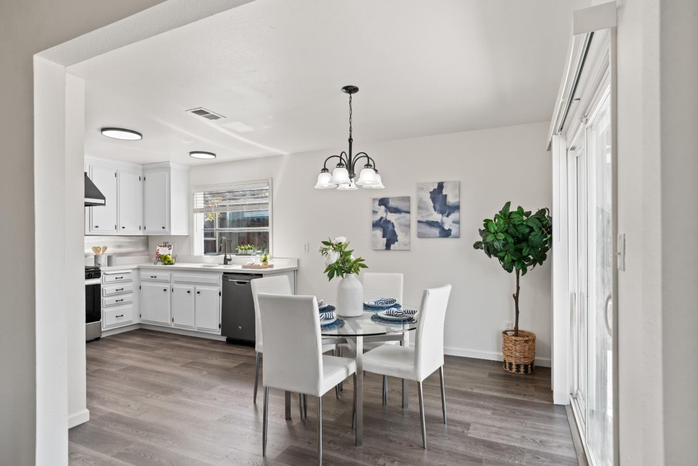 773 Andrea Way Pittsburg, CA 94565 - Photo 7 of 35 a dining room with furniture potted plants and wooden floor