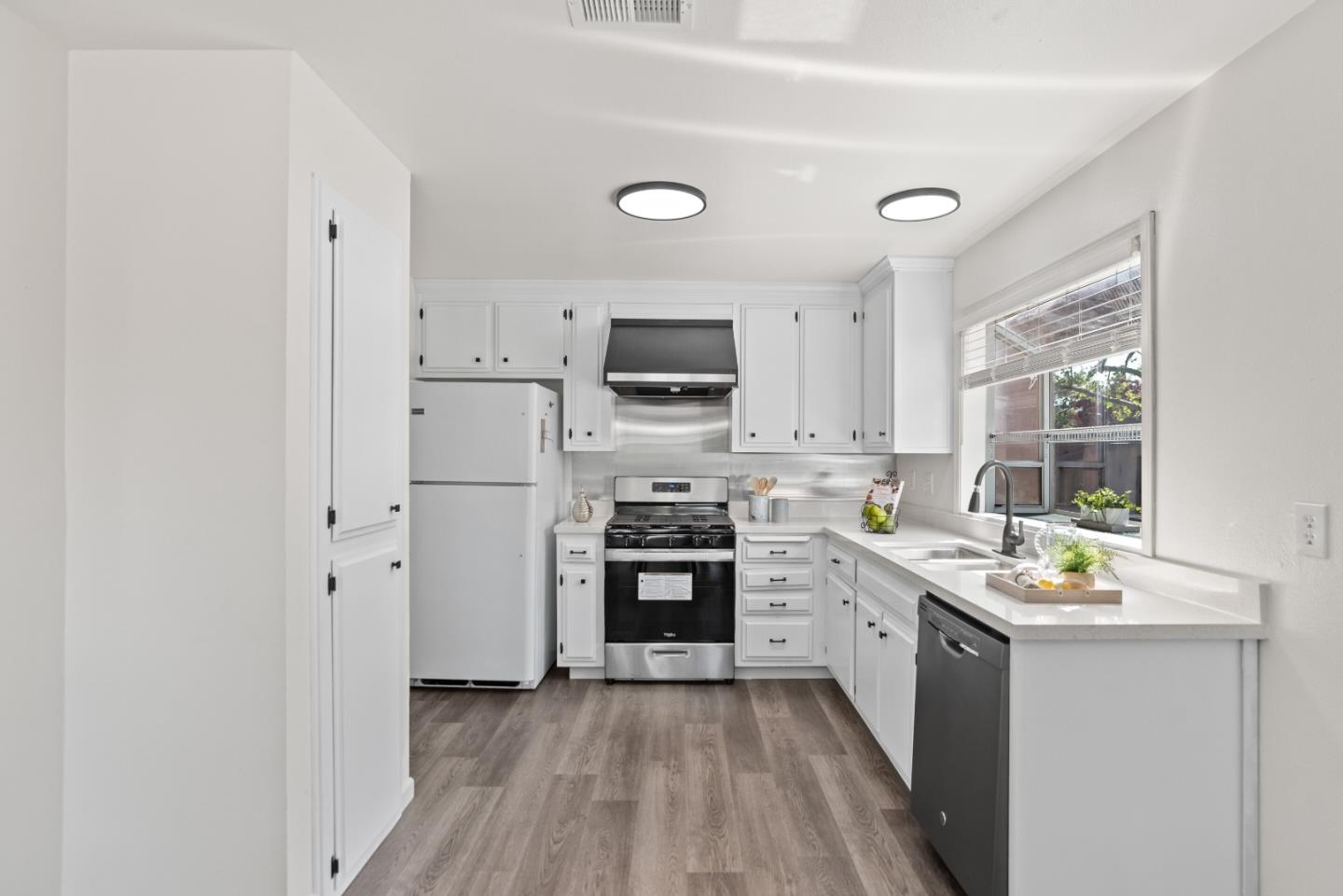 773 Andrea Way Pittsburg, CA 94565 - Photo 9 of 35 a kitchen with stainless steel appliances a stove top oven and a refrigerator