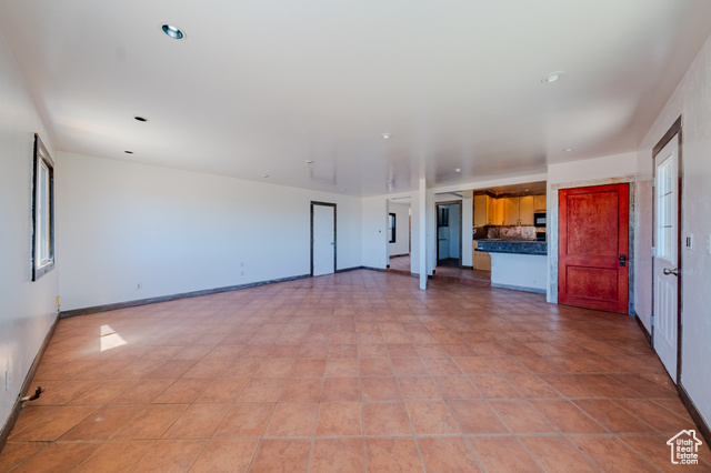 6178 East Zion Road Kanab, UT 84741 - Photo 18 of 48 Unfurnished living room featuring baseboards
