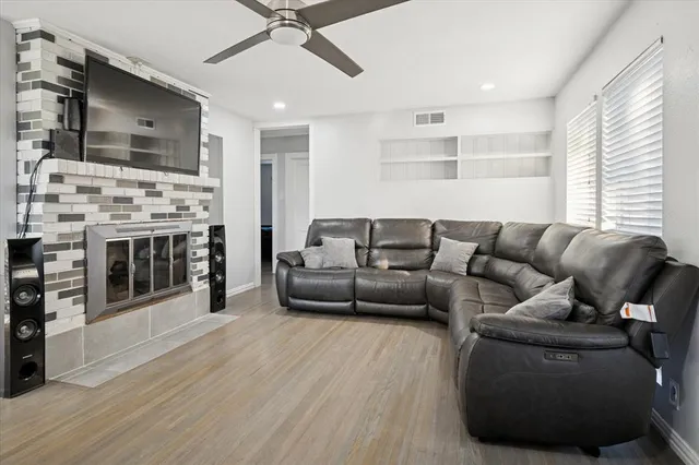 a living room with furniture and a wooden floor