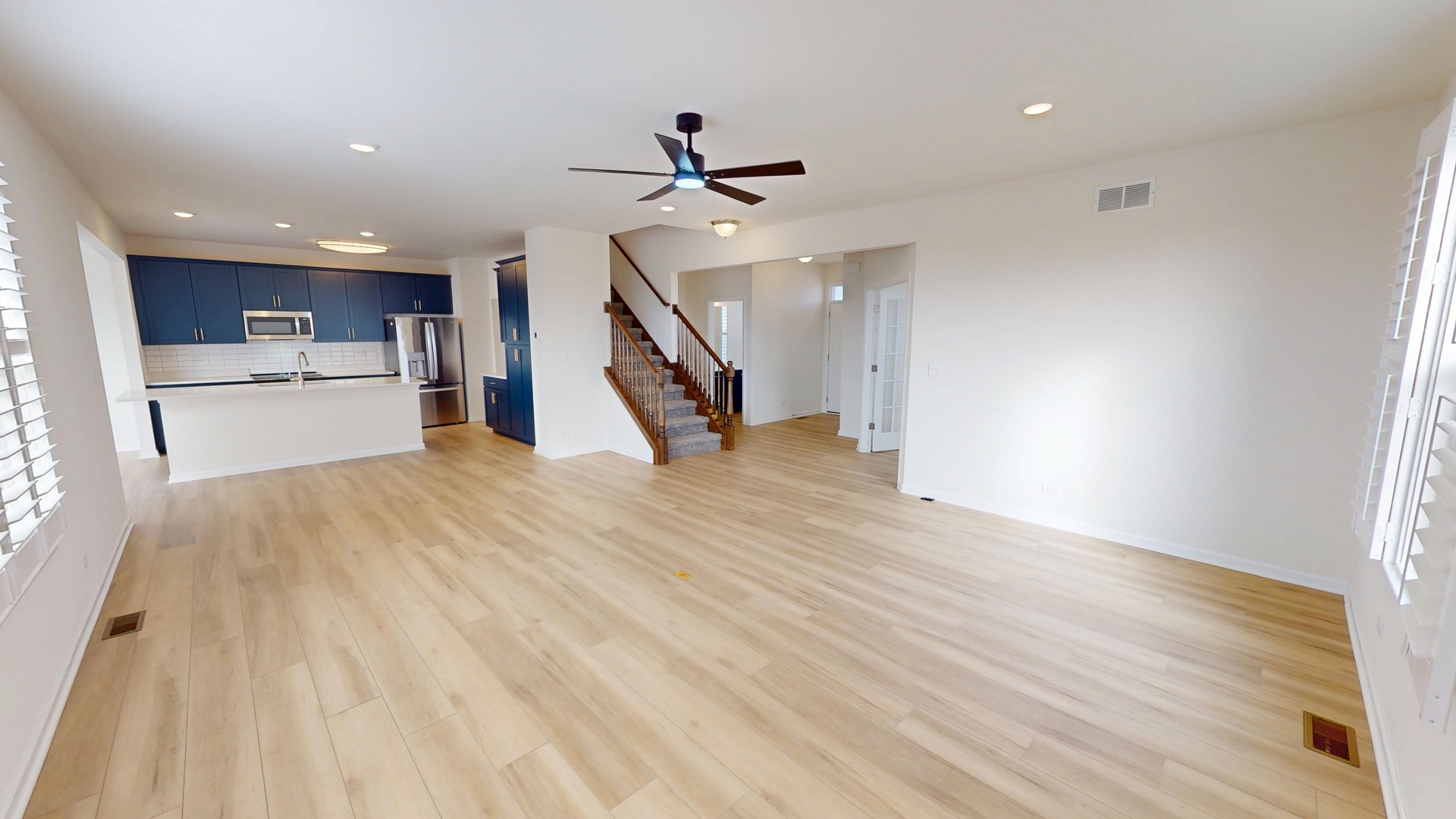 219 Deer Run Trail Poplar Grove, IL 61065 - Photo 6 of 30 a view of a kitchen with wooden floor and a ceiling fan