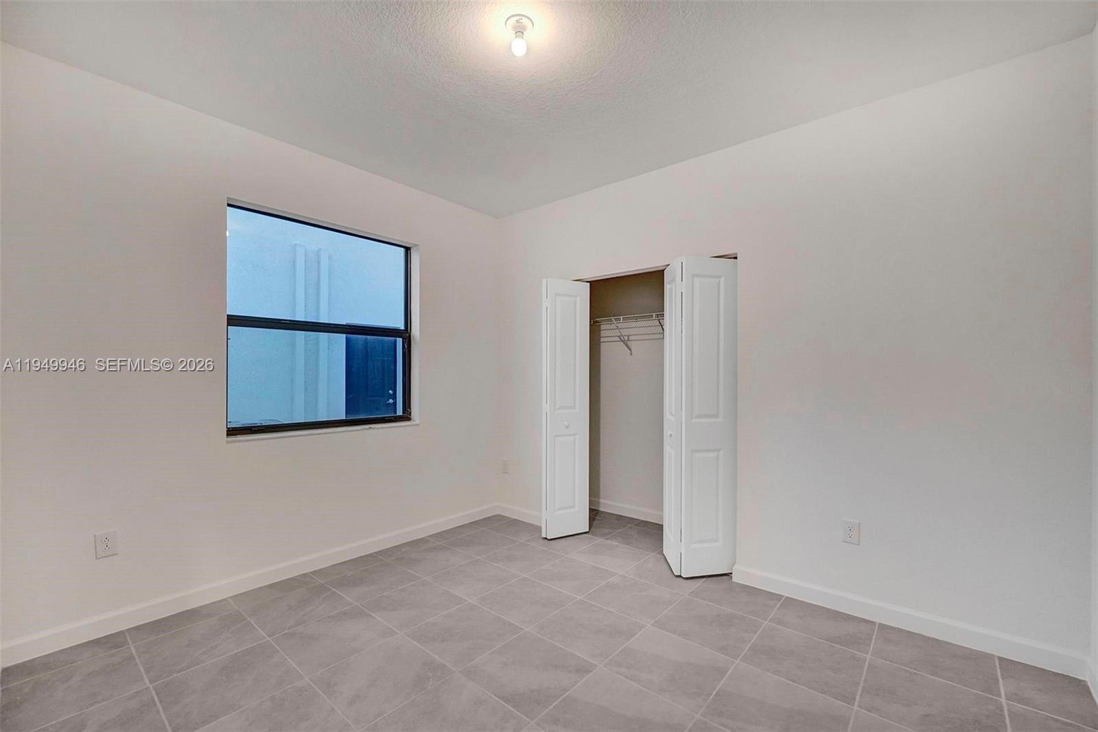 13405 Southwest 285th Street Homestead, FL 33033 - Photo 17 of 59 a view of an empty room with a window