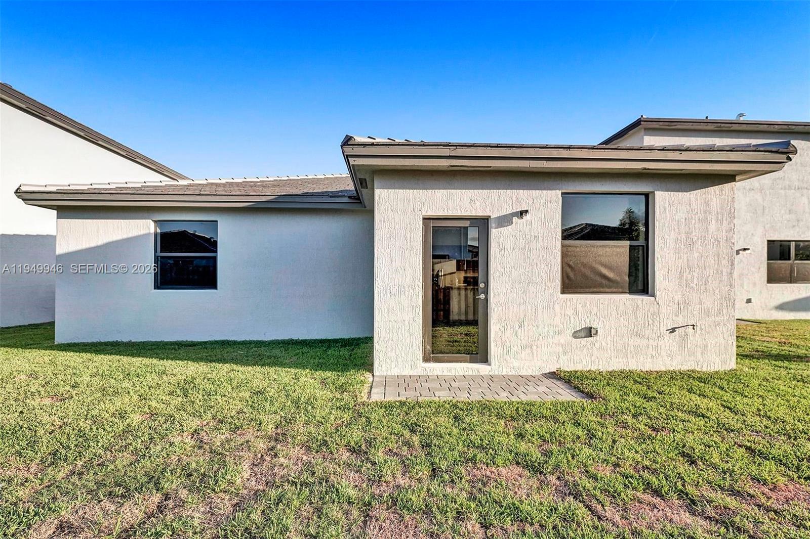 13405 Southwest 285th Street Homestead, FL 33033 - Photo 56 of 59 a view of a house with potted plants and a yard