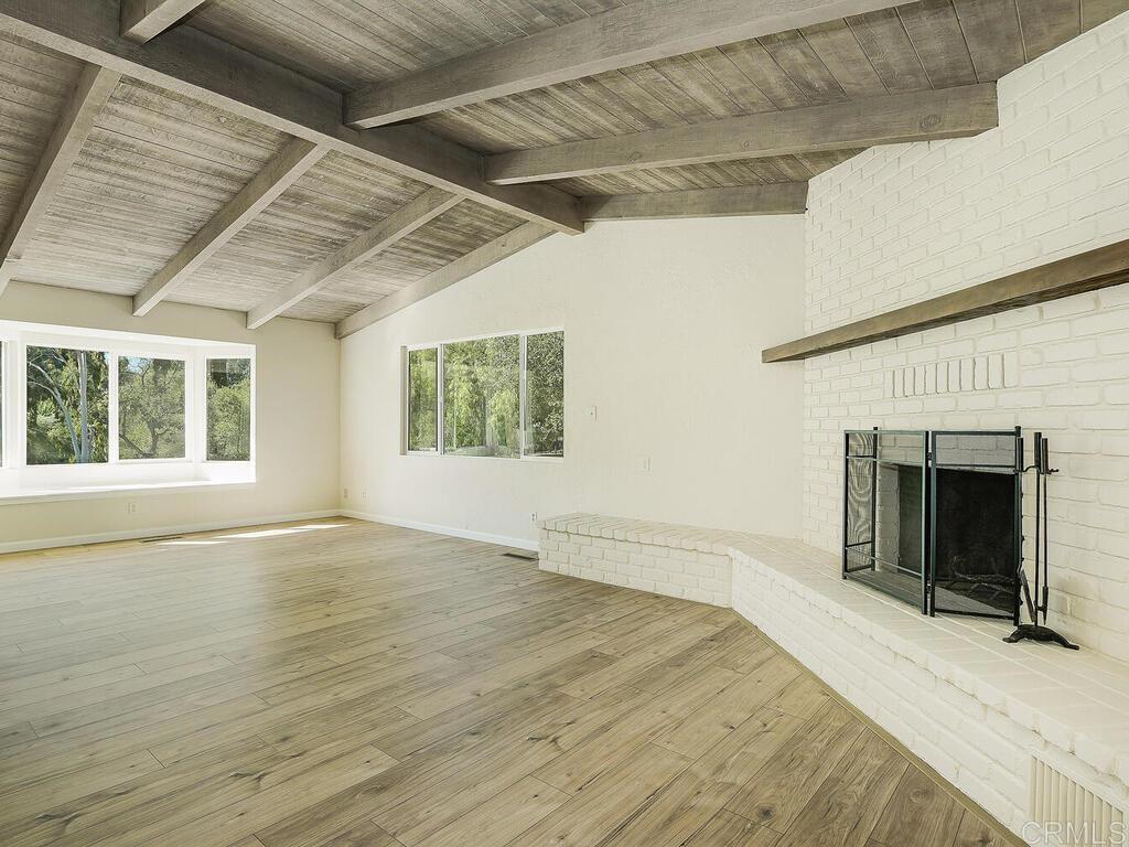 2844 Live Oak Park Road Fallbrook, CA 92028 - Photo 12 of 65 a view of an empty room with a window and fireplace