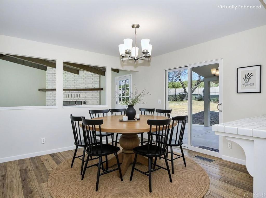 2844 Live Oak Park Road Fallbrook, CA 92028 - Photo 15 of 65 a view of a dining room with furniture a chandelier and wooden floor
