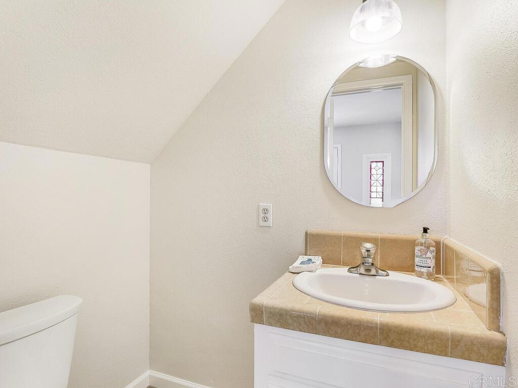 2844 Live Oak Park Road Fallbrook, CA 92028 - Photo 24 of 65 a bathroom with a sink and a mirror
