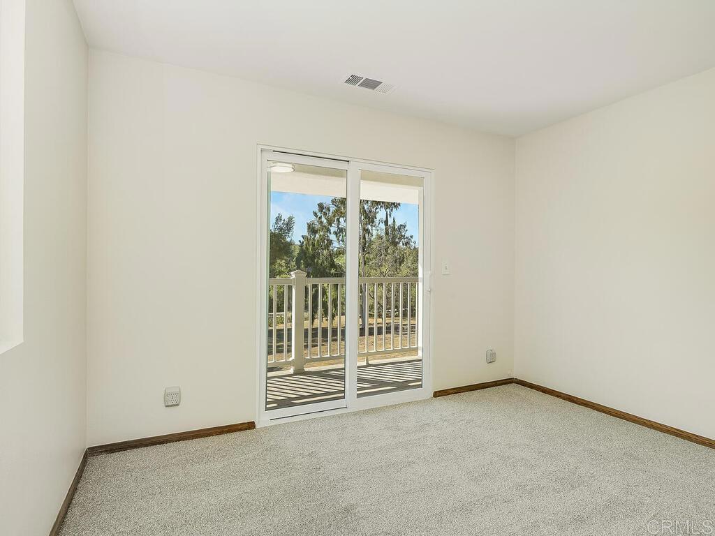 2844 Live Oak Park Road Fallbrook, CA 92028 - Photo 28 of 65 an empty room with wooden floor and windows