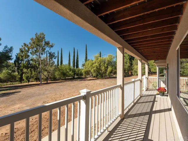 a view of a balcony with wooden floor
