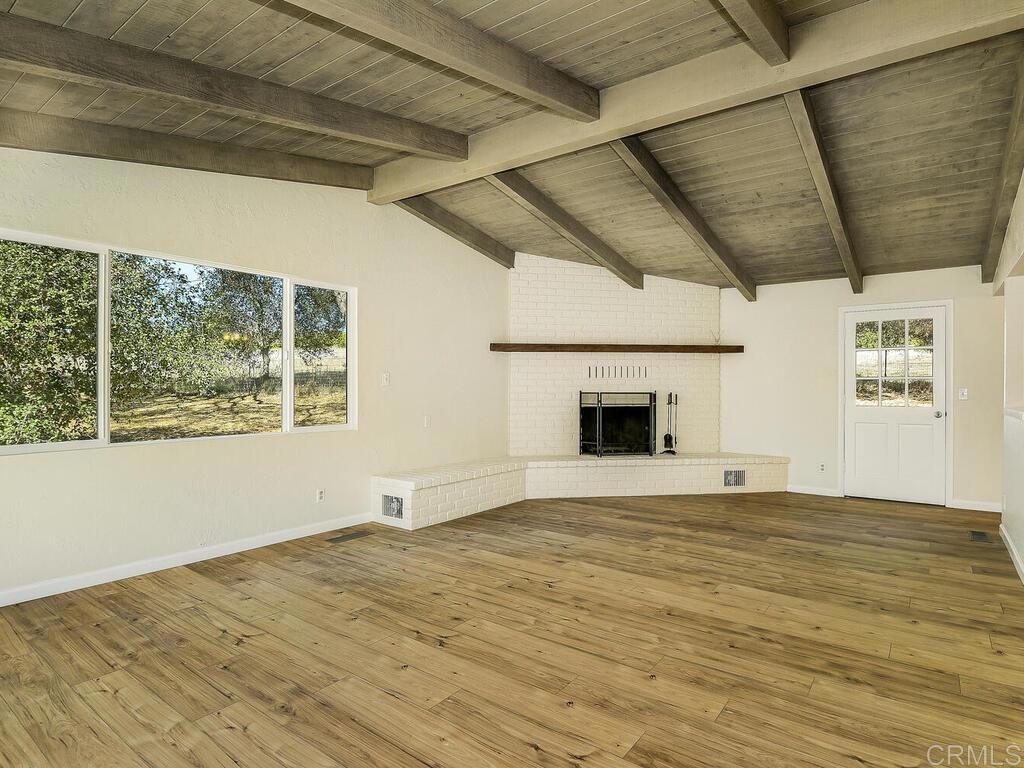 2844 Live Oak Park Road Fallbrook, CA 92028 - Photo 5 of 65 a view of an empty room with window and wooden floor
