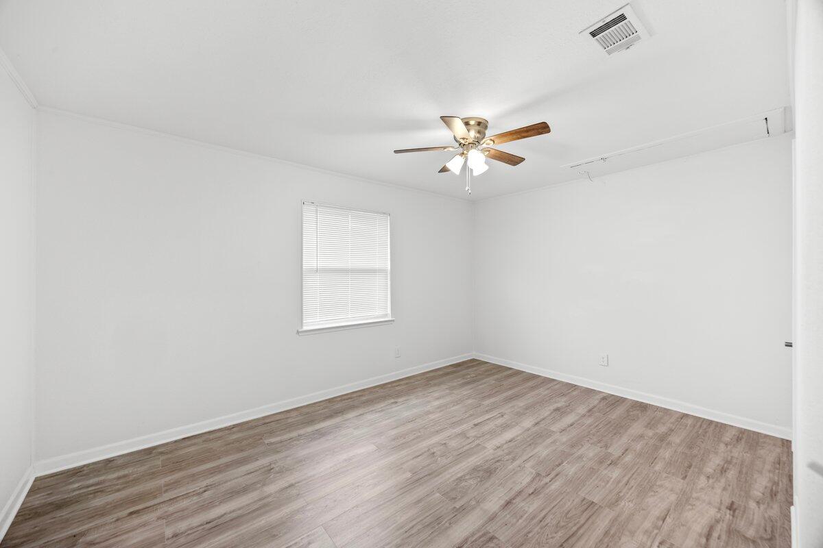 4352 Watkins Street Pace, FL 32571 - Photo 19 of 24 an empty room with a window and a fan