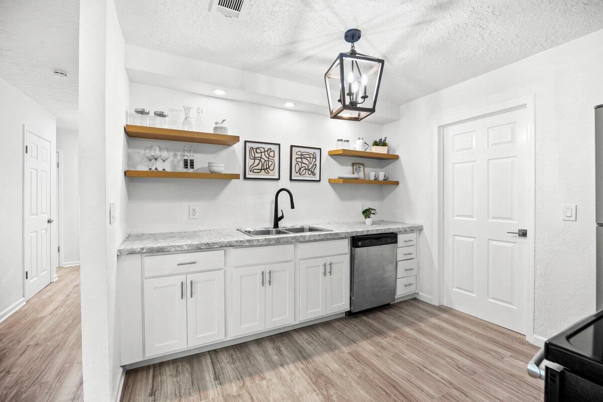 4352 Watkins Street Pace, FL 32571 - Photo 2 of 24 a kitchen with stainless steel appliances granite countertop a sink and stove top oven