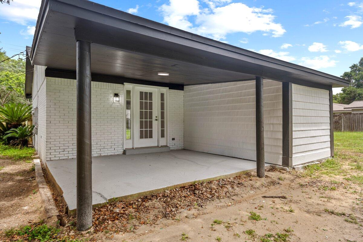 4352 Watkins Street Pace, FL 32571 - Photo 22 of 24 a view of backyard with cabin