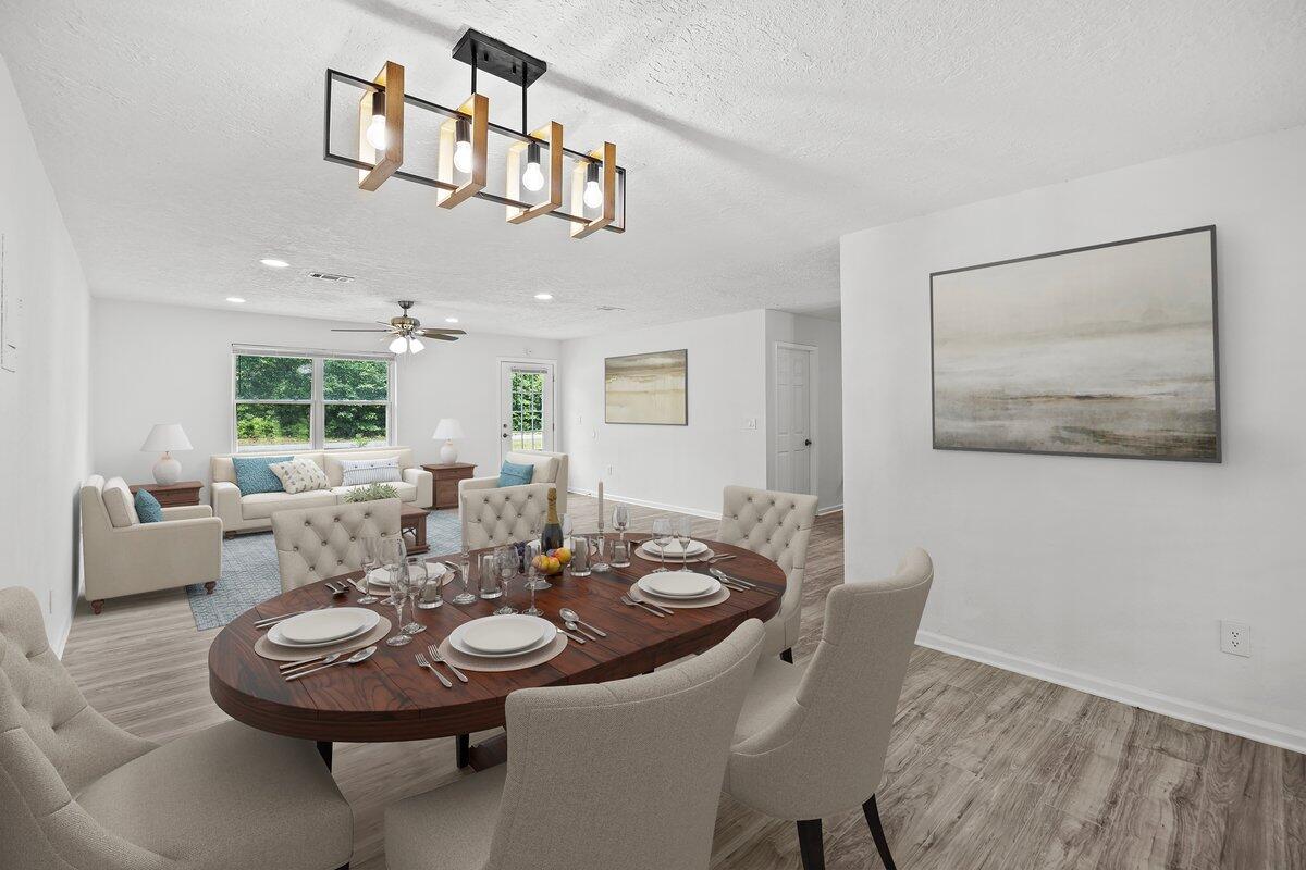 4352 Watkins Street Pace, FL 32571 - Photo 4 of 24 a view of a dining room with furniture and wooden floor