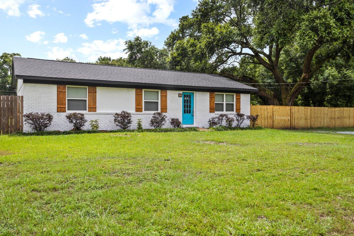 4352 Watkins Street Pace, FL 32571 - Photo 6 of 24 a front view of house with yard and trees