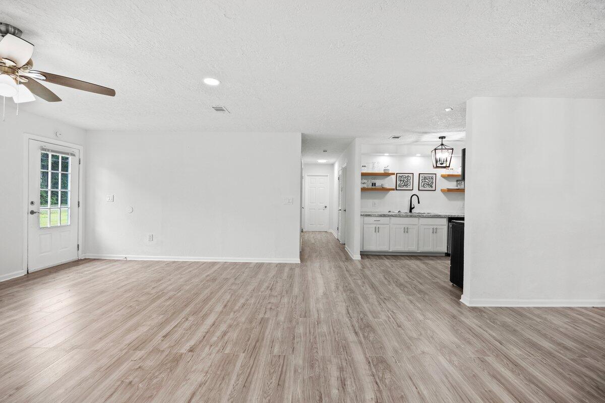 4352 Watkins Street Pace, FL 32571 - Photo 9 of 24 a view of a kitchen with wooden floor