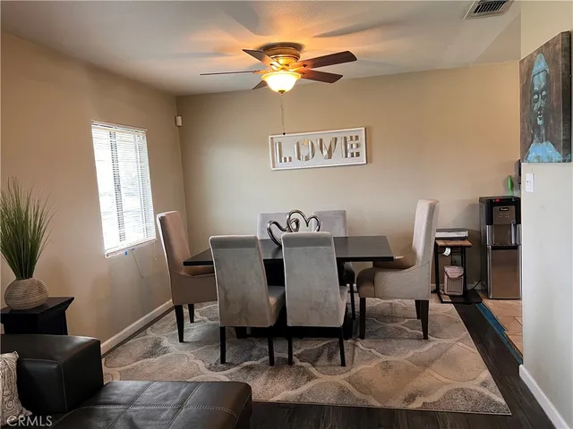a view of a dining room with furniture and a potted plant