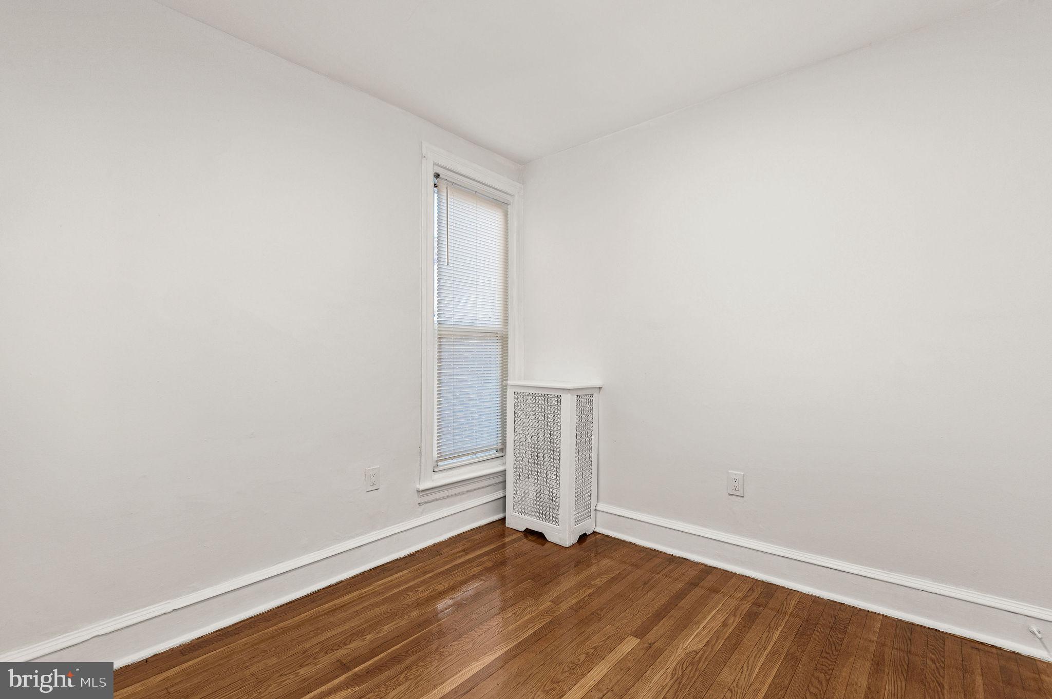 243 East Sheldon Street Philadelphia, PA 19120 - Photo 12 of 23 a view of an empty room with wooden floor