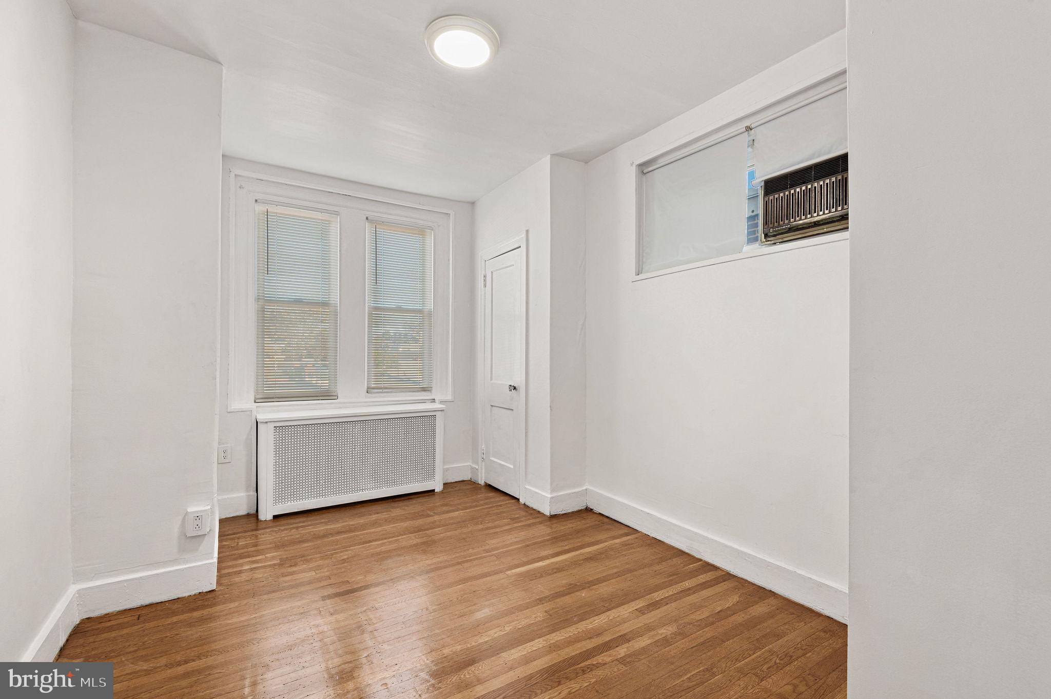 243 East Sheldon Street Philadelphia, PA 19120 - Photo 15 of 23 a view of an empty room with wooden floor and a window