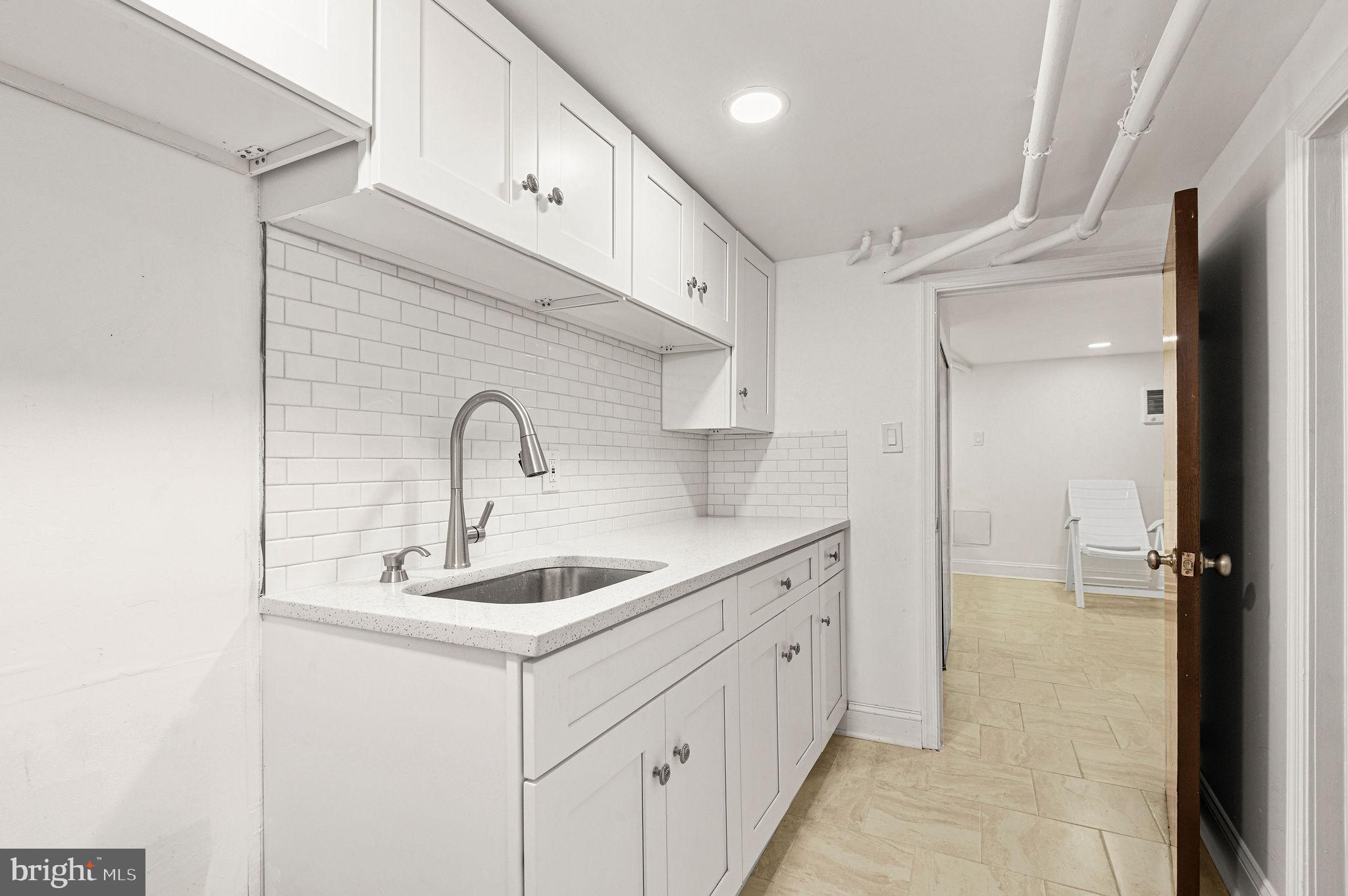 243 East Sheldon Street Philadelphia, PA 19120 - Photo 18 of 23 a bathroom with a sink and mirror