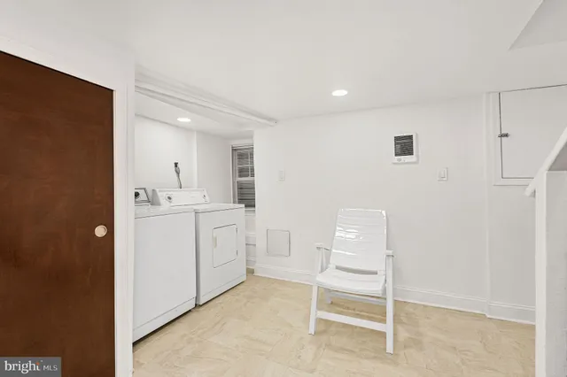 a room with a white cabinets and white appliances