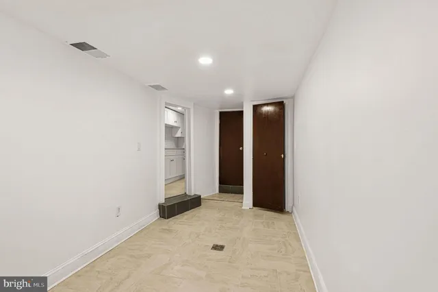 an empty room with closet and bathroom