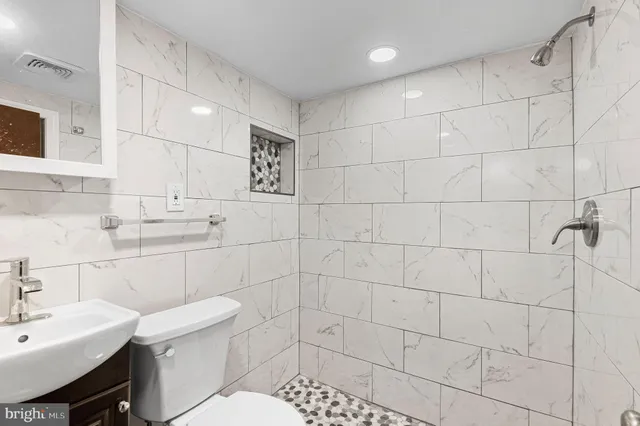 a bathroom with a sink toilet and shower