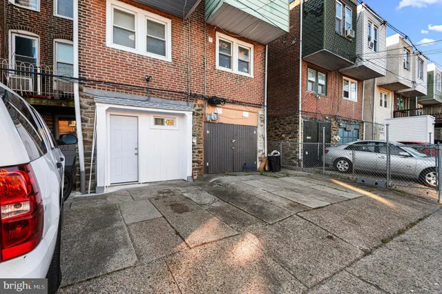 a couple of cars parked in front of a building