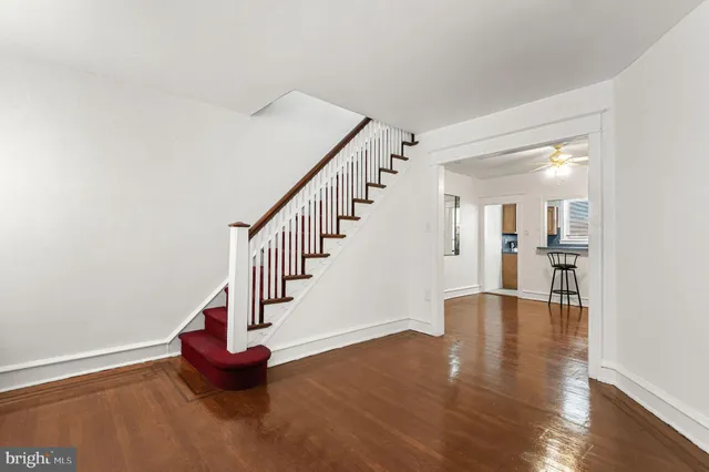 a view of entryway and hall with wooden floor