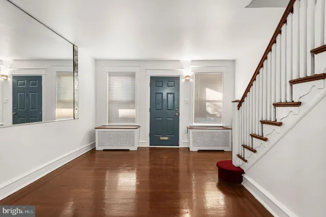 a view of staircase with white walls and wooden floor