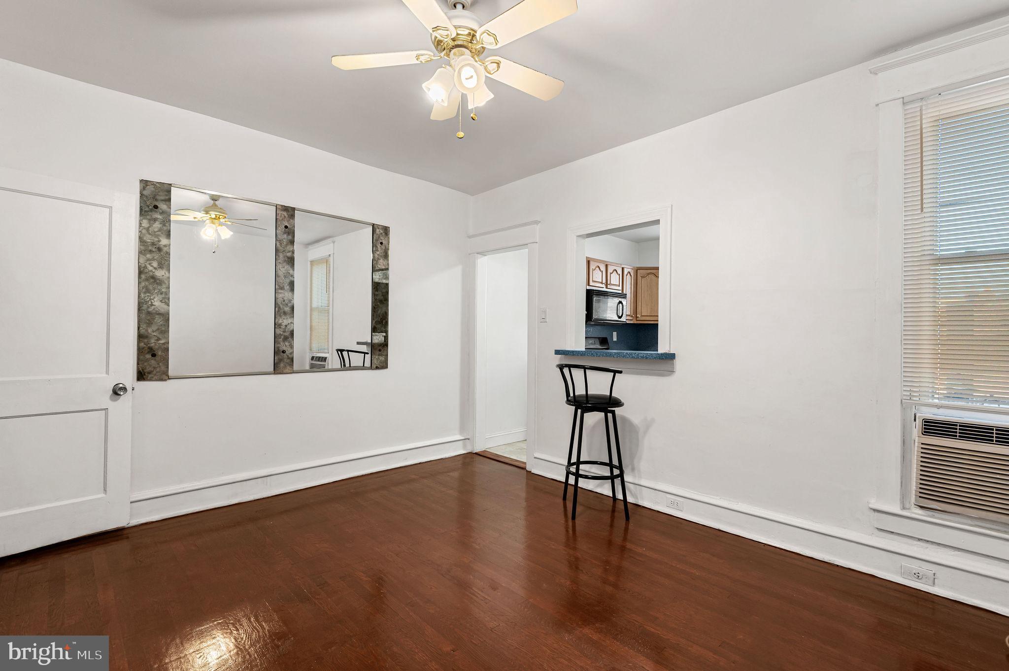 243 East Sheldon Street Philadelphia, PA 19120 - Photo 7 of 23 a view of an empty room with wooden floor and a window