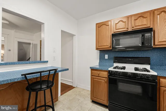 a kitchen with a stove and a microwave