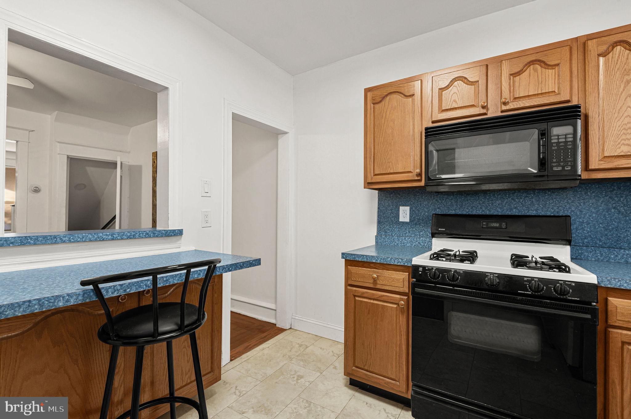 243 East Sheldon Street Philadelphia, PA 19120 - Photo 8 of 23 a kitchen with a stove and a microwave