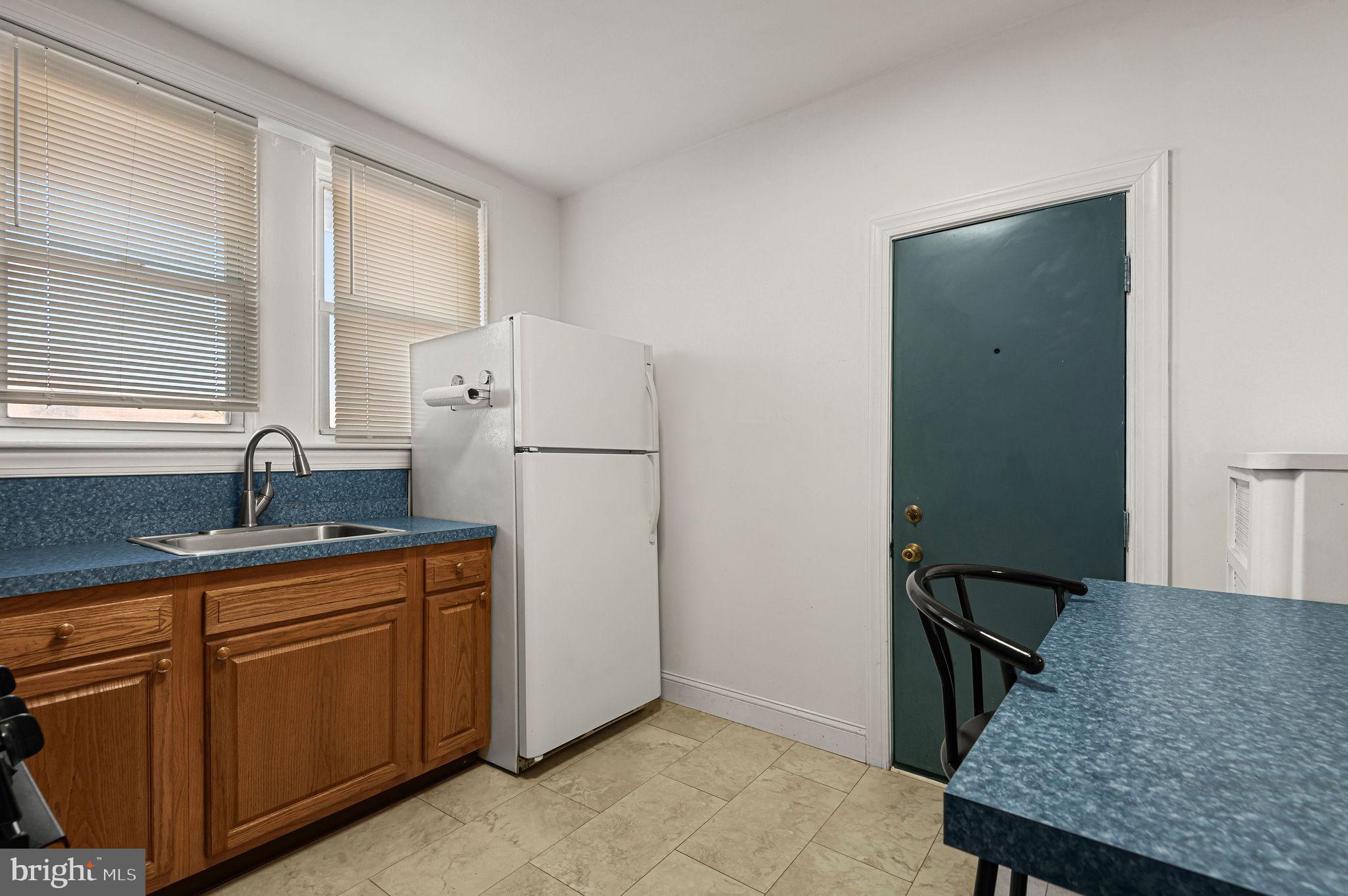 243 East Sheldon Street Philadelphia, PA 19120 - Photo 9 of 23 a kitchen with a granite countertop sink stove and refrigerator