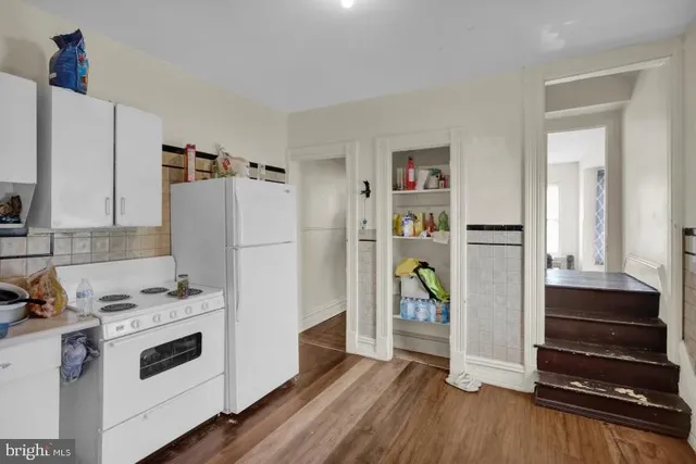 a kitchen with stainless steel appliances a refrigerator and a stove top oven