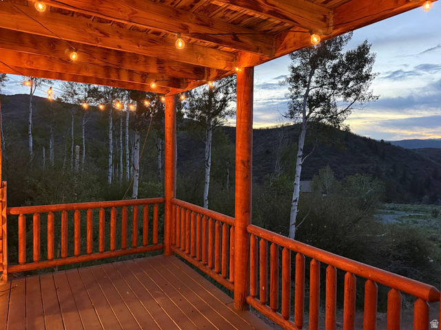 15253 Mill Road, Unit 62 Huntsville, UT 84317 - Photo 44 of 48 Covered outdoor deck featuring exposed wood beams and string lighting