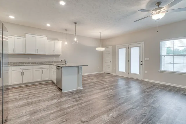 a view of a kitchen with a stove cabinets and wooden floor