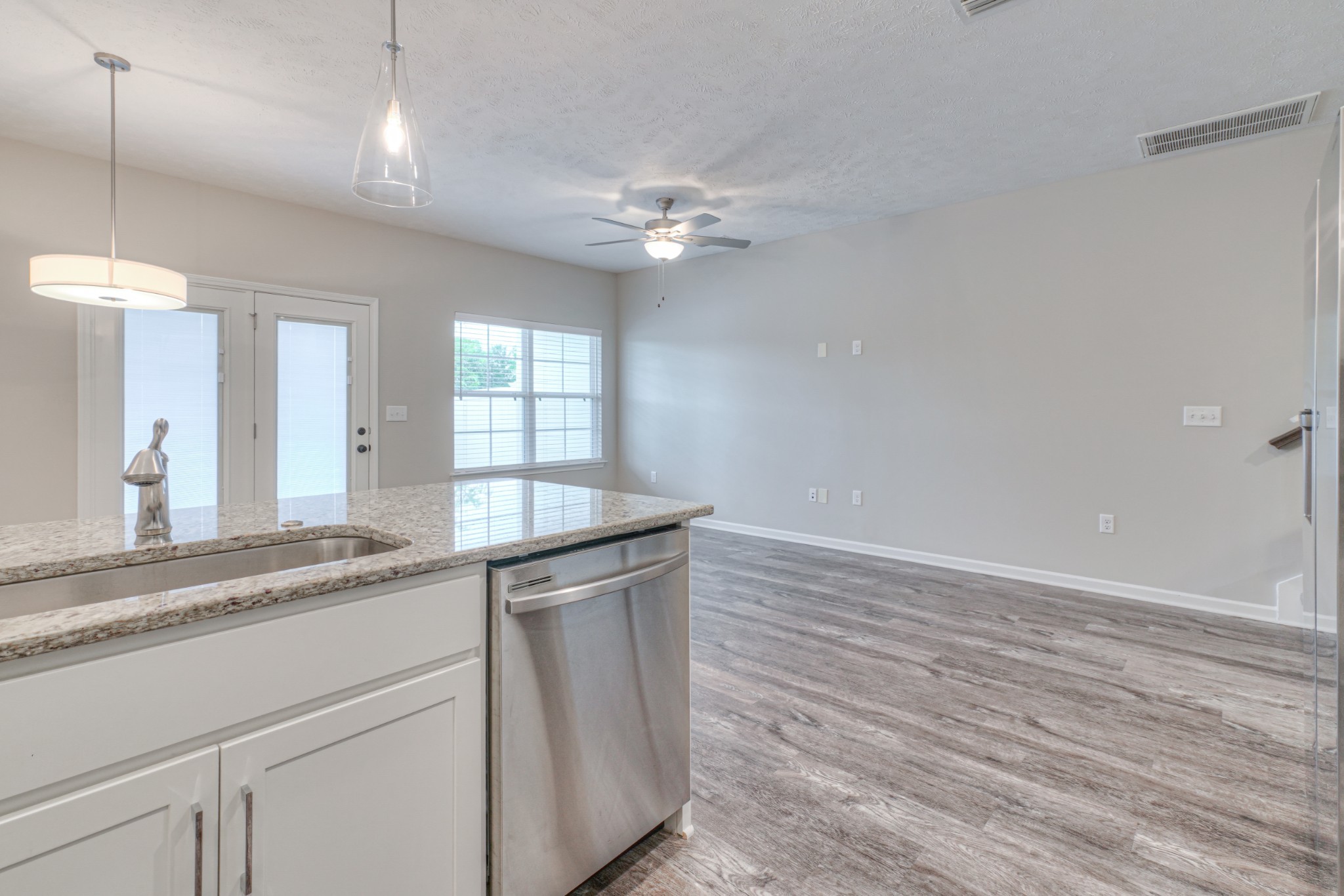 4318 Spyglass Drive Murfreesboro, TN 37127 - Photo 9 of 21 a kitchen with granite countertop a sink cabinets and wooden floor