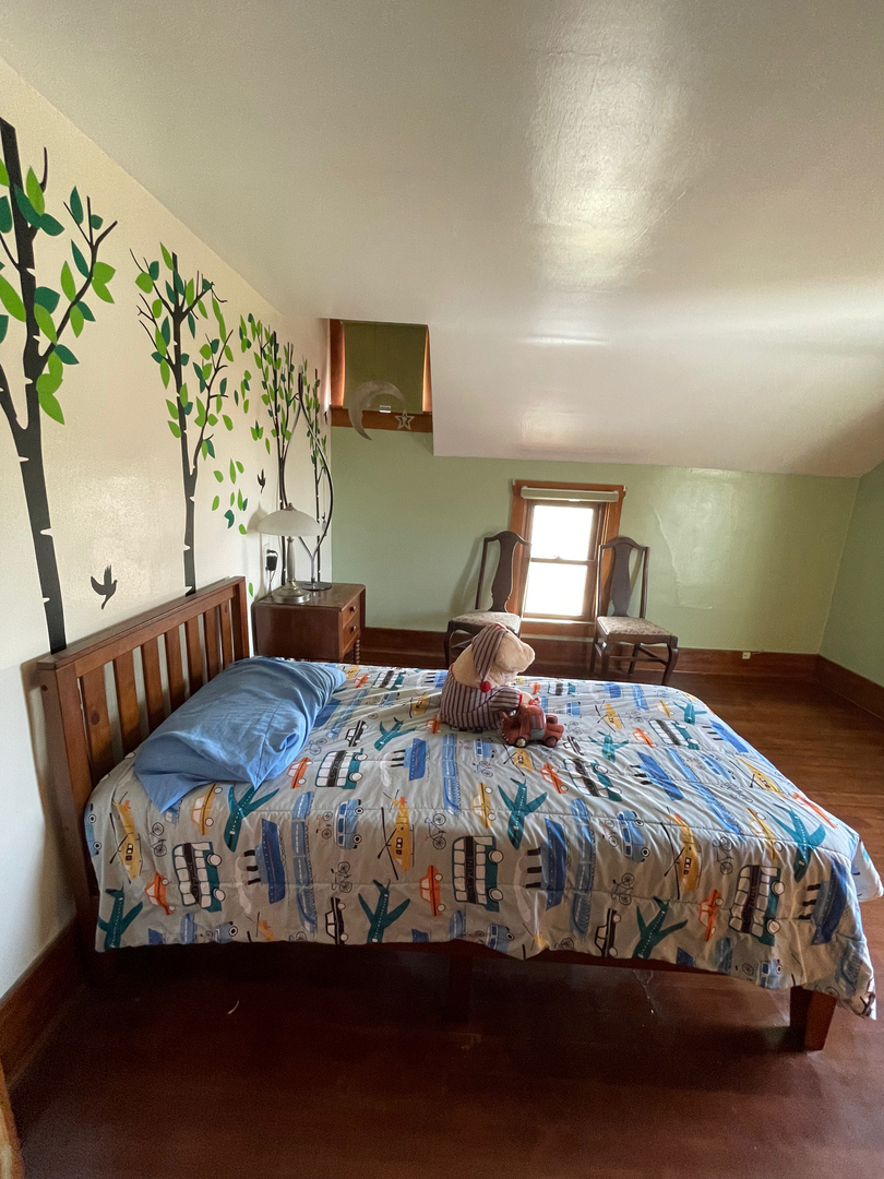 1733 Plock Road Dixon, IL 61021 - Photo 19 of 23 a bedroom with a bed and a flat tv screen on dresser