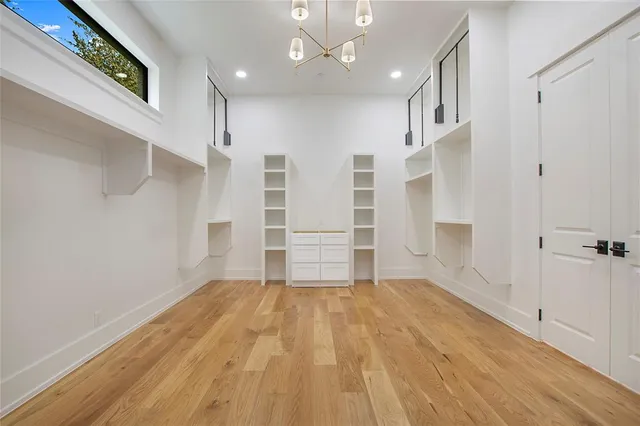 a view of empty room with wooden floor and windows