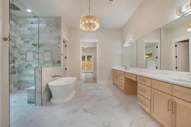 a spacious bathroom with a granite countertop sink a toilet a mirror and shower