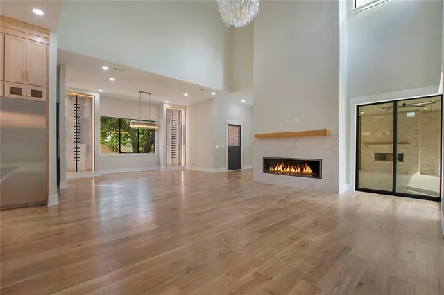 an entryway with an empty room and fire place