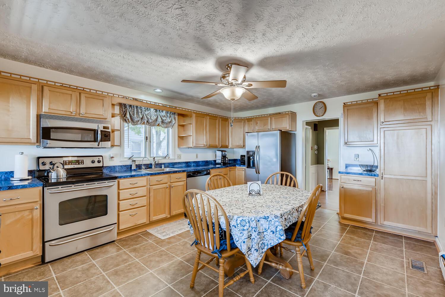 418 Carvel Beach Road Curtis Bay, MD 21226 - Photo 20 of 54 a kitchen with stainless steel appliances granite countertop a kitchen island hardwood floor sink stove dining table and chairs