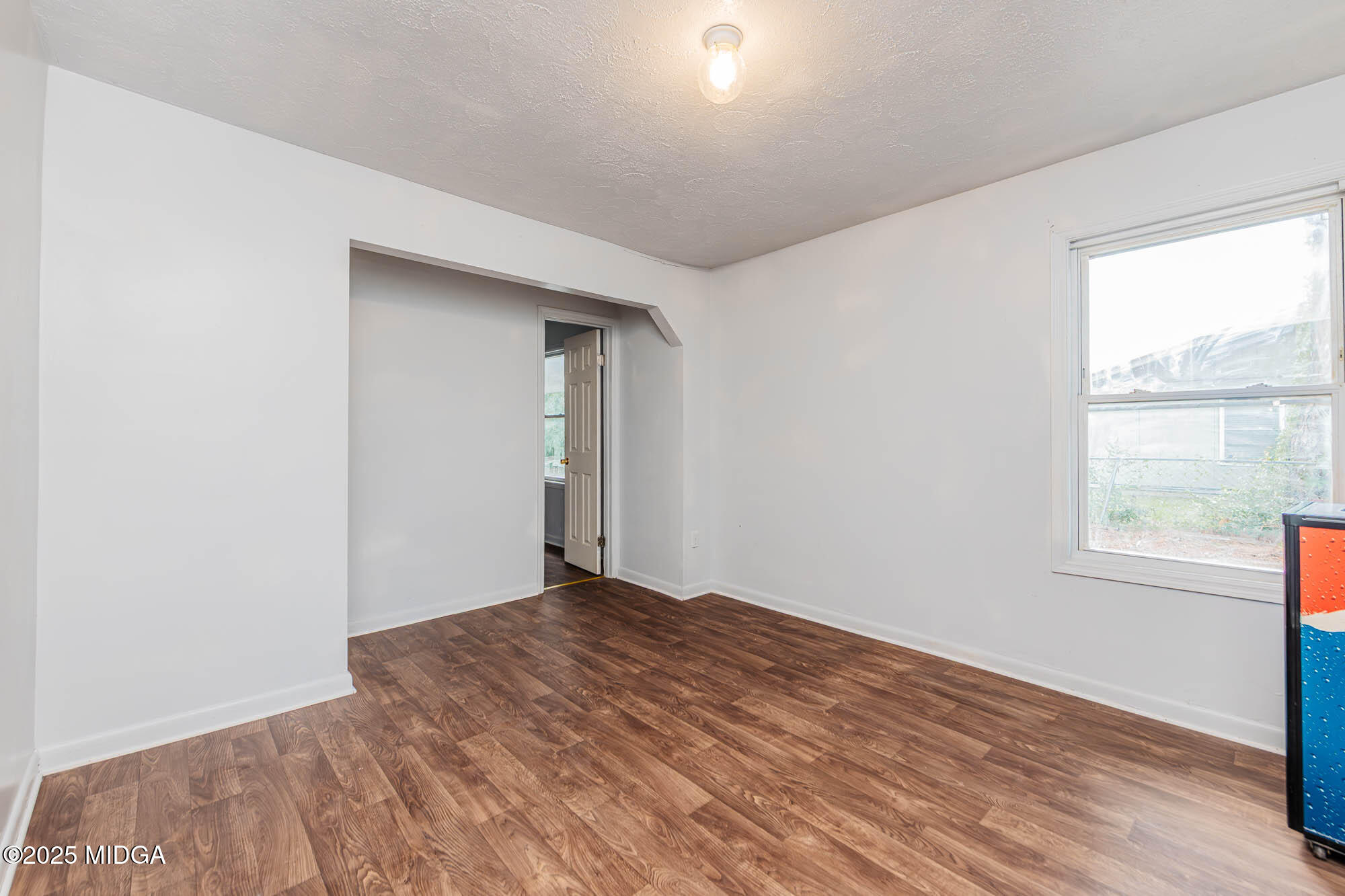 125 Suzanne Drive Warner Robins, GA 31093 - Photo 13 of 50 an empty room with wooden floor and windows